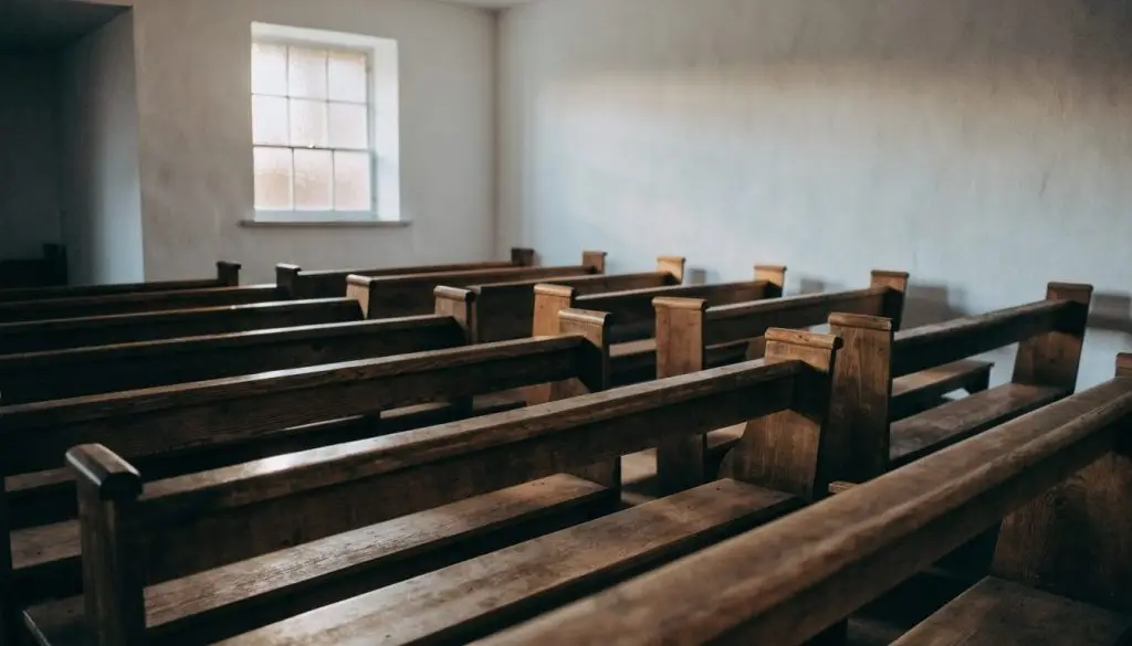 Empty wooden pews in morning light inside a small church sanctuary